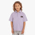 Young boy wearing a lavender Calvin Klein Kids Pique Badge Golfer polo shirt with the CK logo, paired with gray shorts.