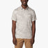 Columbia Mens Tech Polo Short Sleeve Golfer in dark stone (light gray/beige camo pattern), worn by a smiling man, front view.