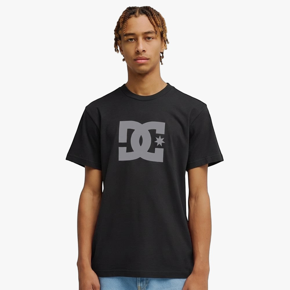 Dc Mens Dc Star Short Sleeve Tee in black featuring a gray DC star logo on the chest, modeled on a male.