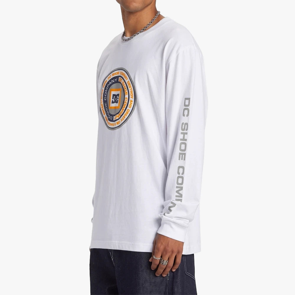 Dc Mens Throwback Long Sleeve Tee in white, featuring a circular graphic logo and vertical sleeve text, worn by a male model.