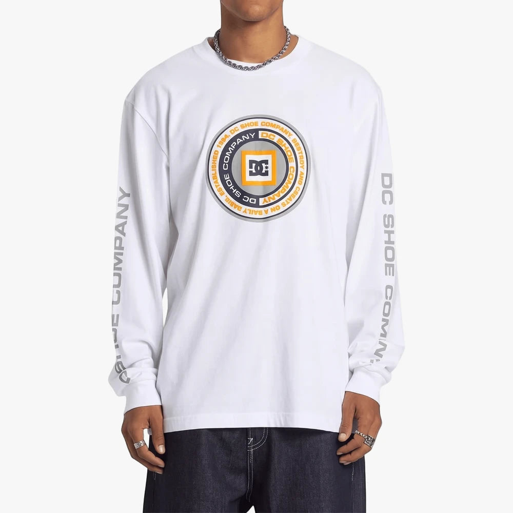 Dc Mens Throwback Long Sleeve Tee in white with a circular brand logo on the chest and text on the sleeves, worn by a model.