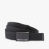 Black DC Web Belt with a logo buckle, coiled on a flat surface, offering a durable and adjustable accessory for men.