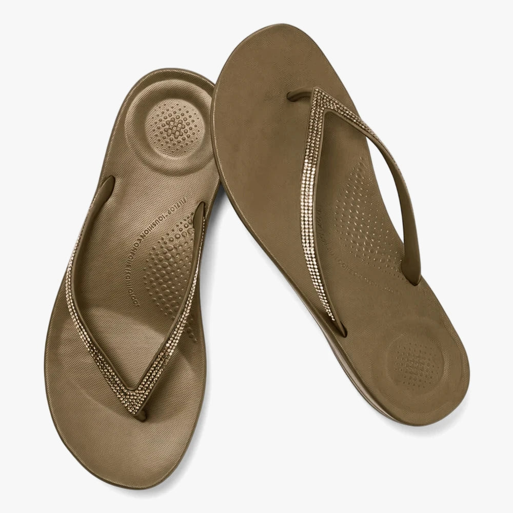 Pair of military olive Fit Flop I Qushion Ombre Sparkle sandals with rhinestone-studded straps, displayed from an elevated