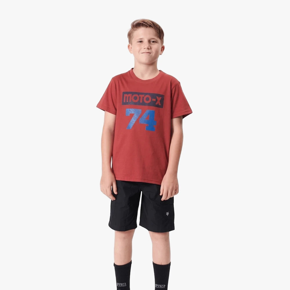 Fox Boys 74 Short Sleeve Tee Scarlett on a boy, paired with black shorts and socks, front view, standing.