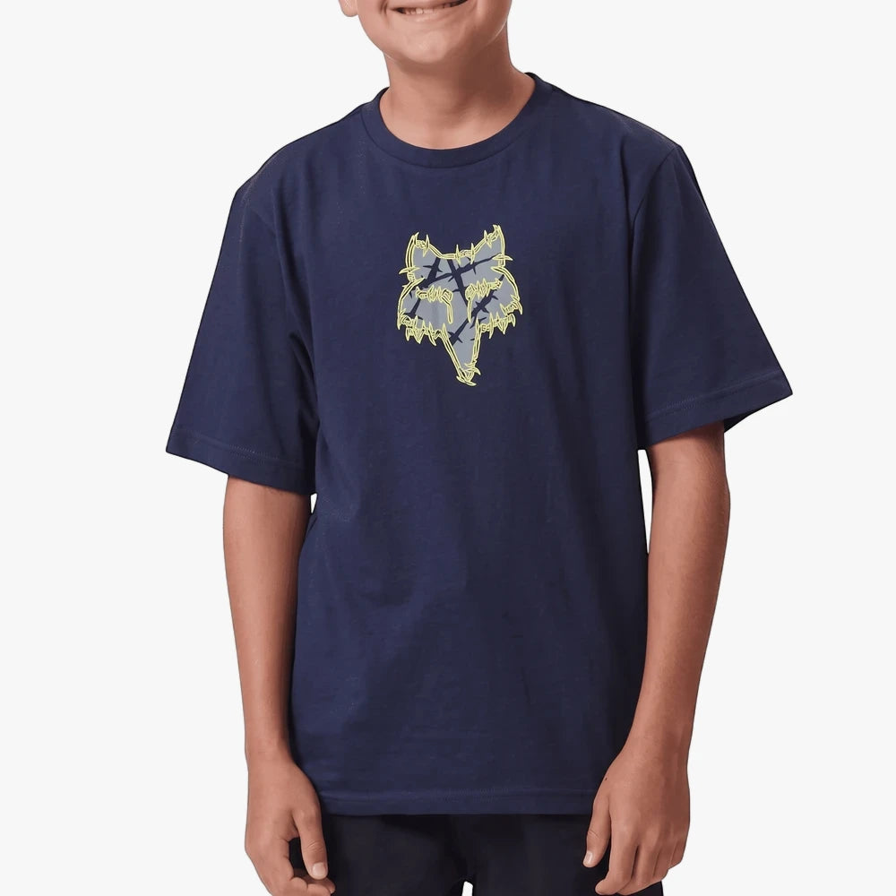 A young boy models a navy Fox boys barbed short sleeve tee featuring a distinctive yellow and gray fox head logo.