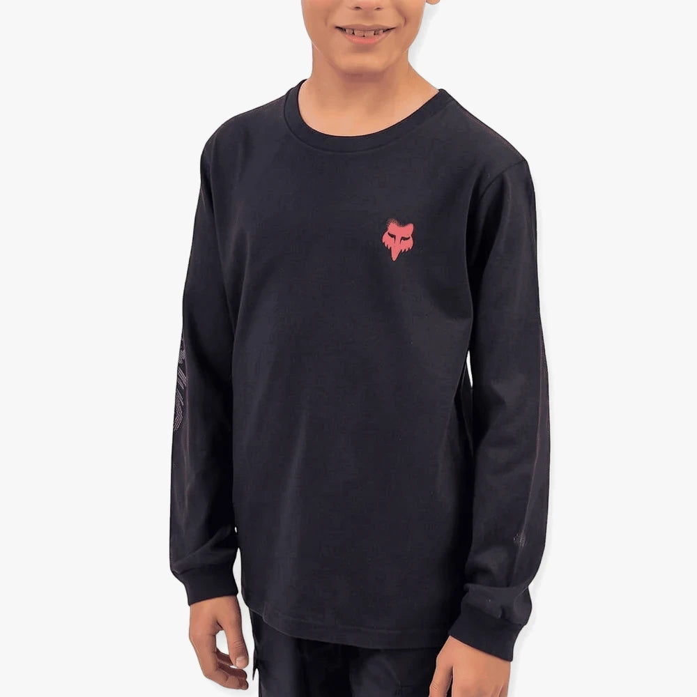 A boy wearing a black long-sleeve Fox t-shirt with a red fox head logo and white graphic on sleeve, chest-down view.