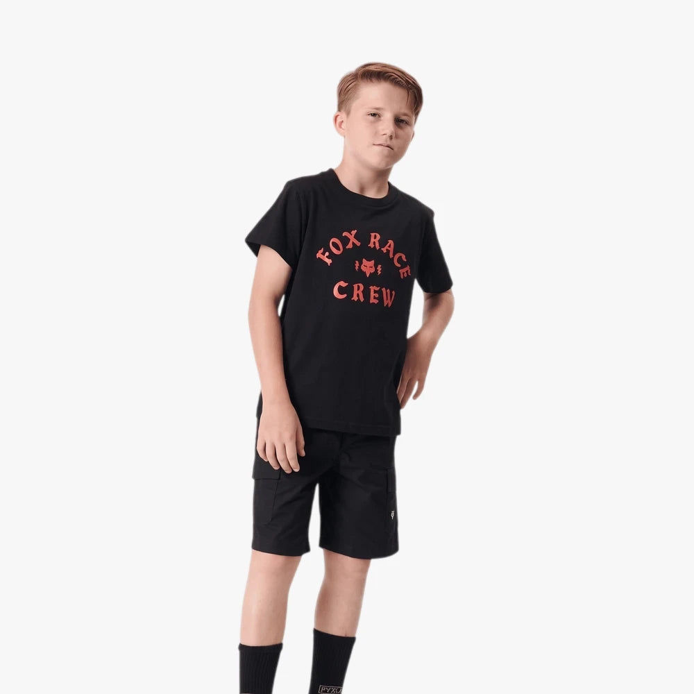 Young boy wearing a black Fox Boys Race short sleeve tee with a red &