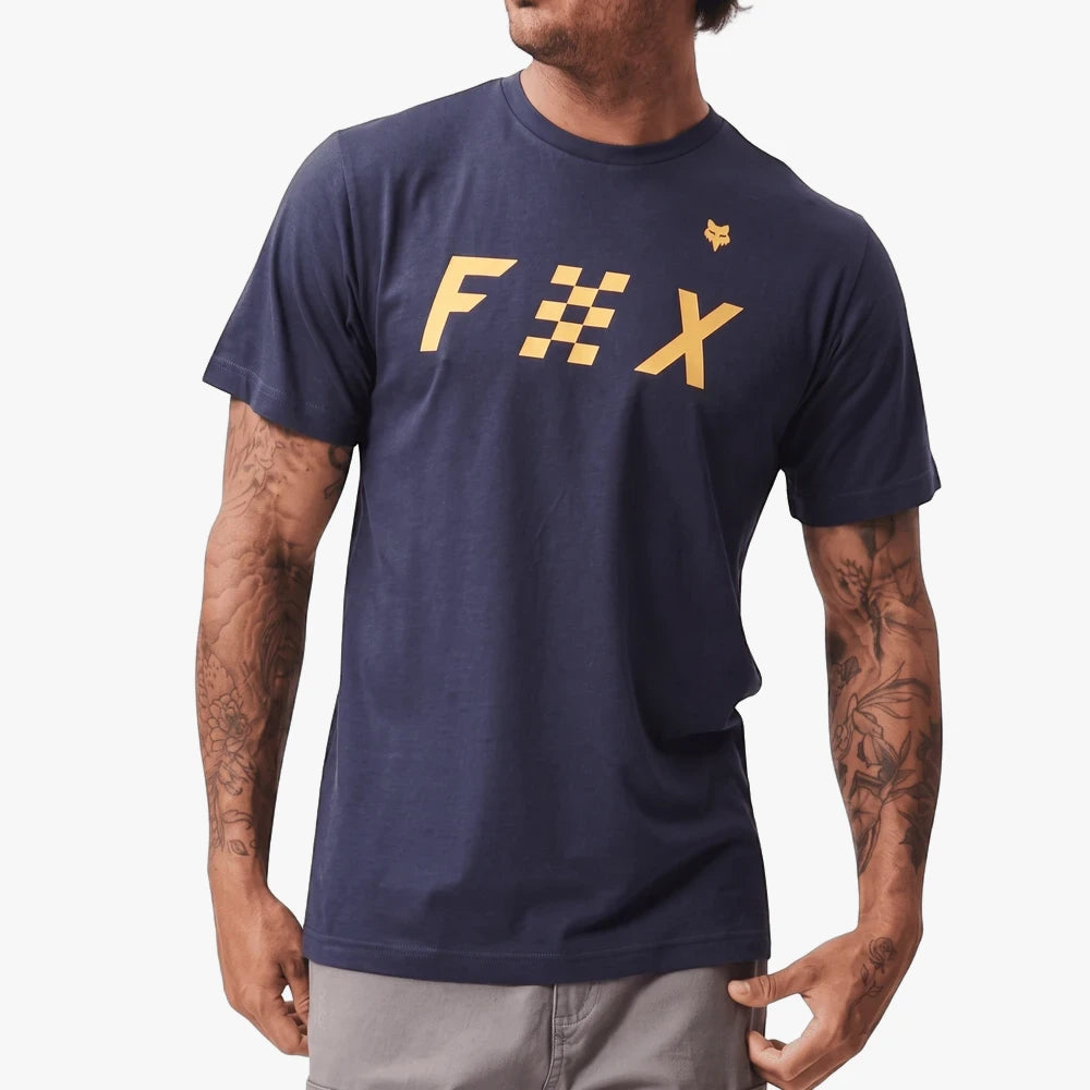 Fox Mens Checkered Short Sleeve Tee in Summit Navy, worn by a model with tattooed arms and grey pants, photographed
