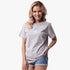A smiling woman wears a light grey heather Fox Women&