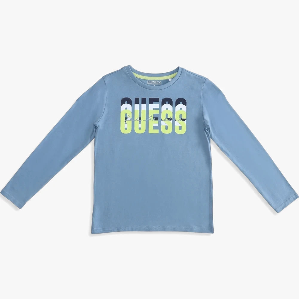 Guess Boys Long Sleeve Tee in medium blue, featuring a prominent layered GUESS logo on the chest in white, black, and neon