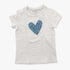White Guess Girls short sleeve tee with a blue heart graphic filled with various words, laid flat on a surface.