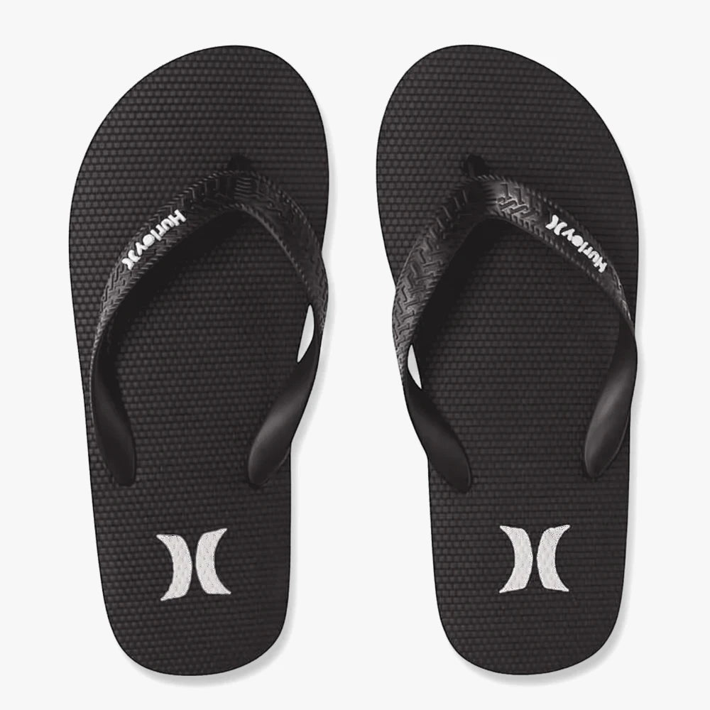 Pair of black Hurley Iconic Flip Flops featuring textured soles and white Hurley logos on both the straps and heels.