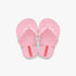 A pair of light pink Ipanema Girls Zig sandals, featuring a thong style with wavy-edged straps and small red tags on the