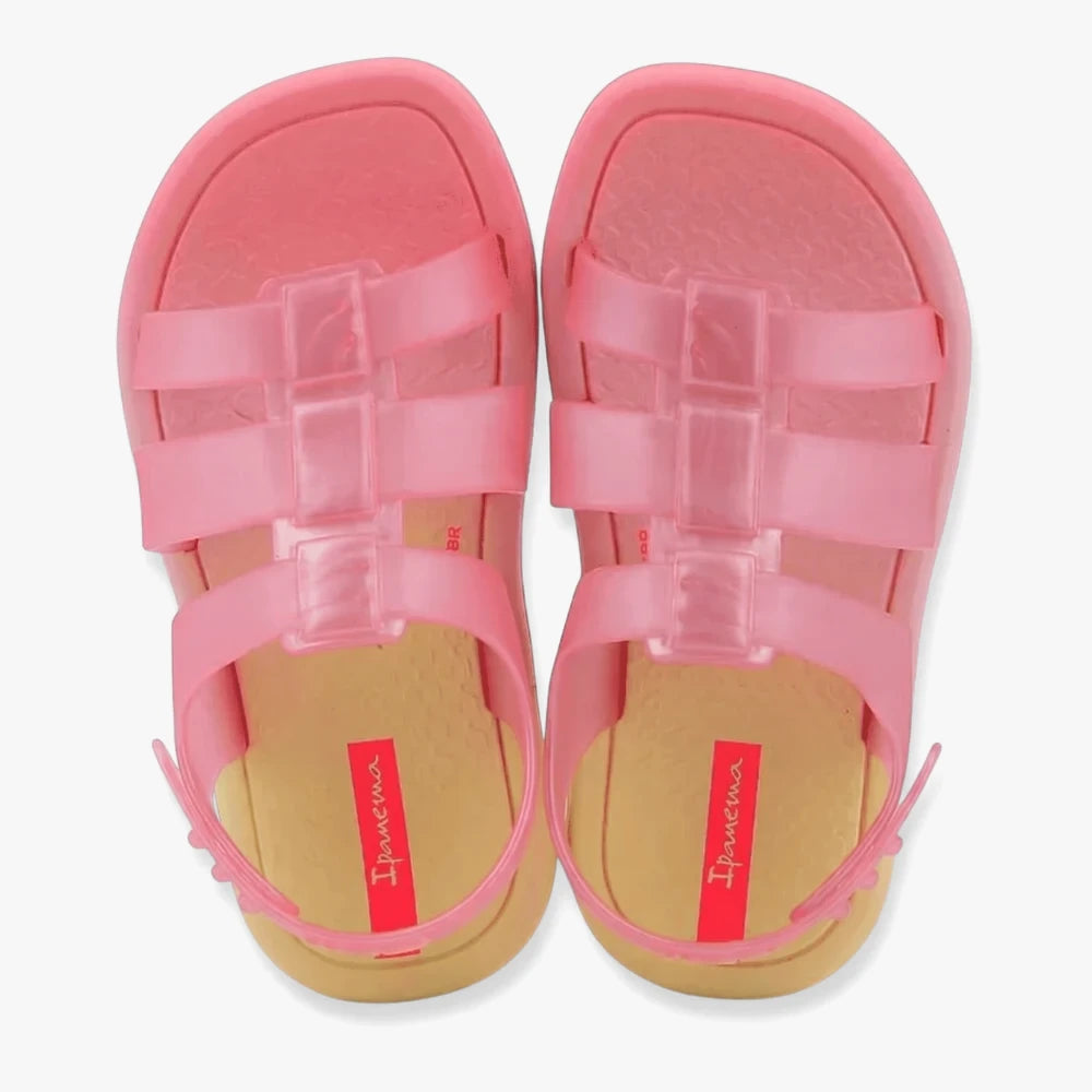 Pair of Ipanema Infant Girls Go Style Sandals in translucent pink and yellow, featuring jelly straps and a buckle closure,