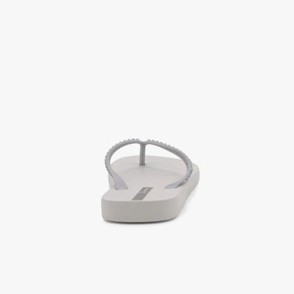 Grey silver Ipanema Womens Essence flip-flop sandal with a beaded thong strap, shown in a rear-quarter view.
