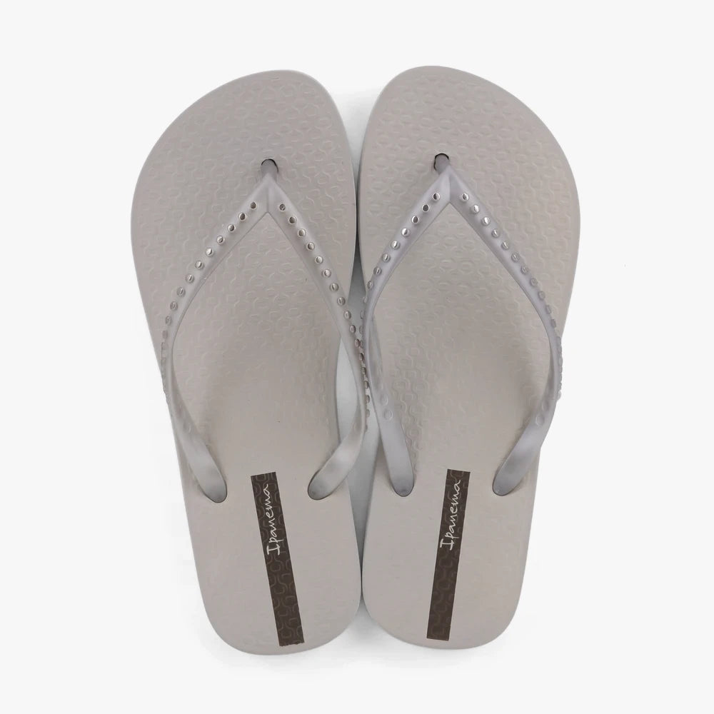 A pair of grey and silver Ipanema Womens Essence sandals, featuring translucent straps with studded details and a textured