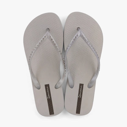 A pair of grey and silver Ipanema Womens Essence sandals, featuring translucent straps with studded details and a textured