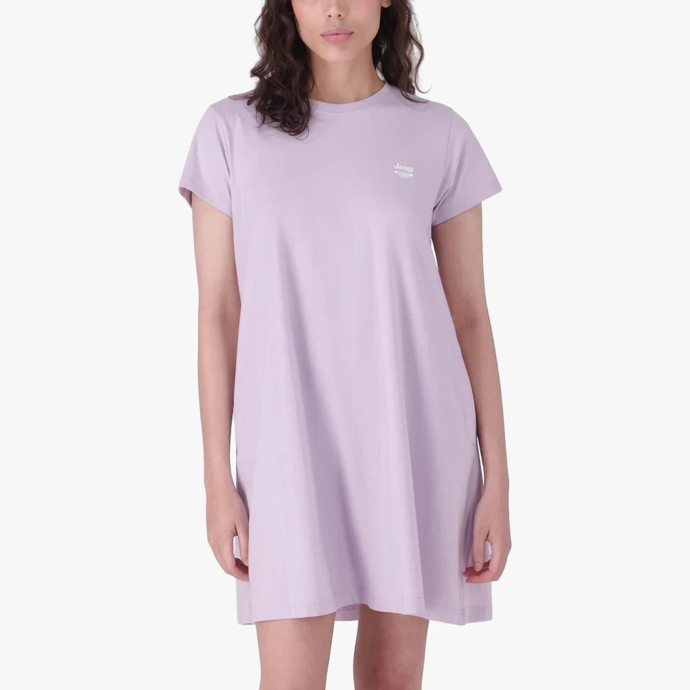 A woman models a short-sleeved, crew-neck Jeep City Lite Dress in digital lavender, featuring a small white logo.