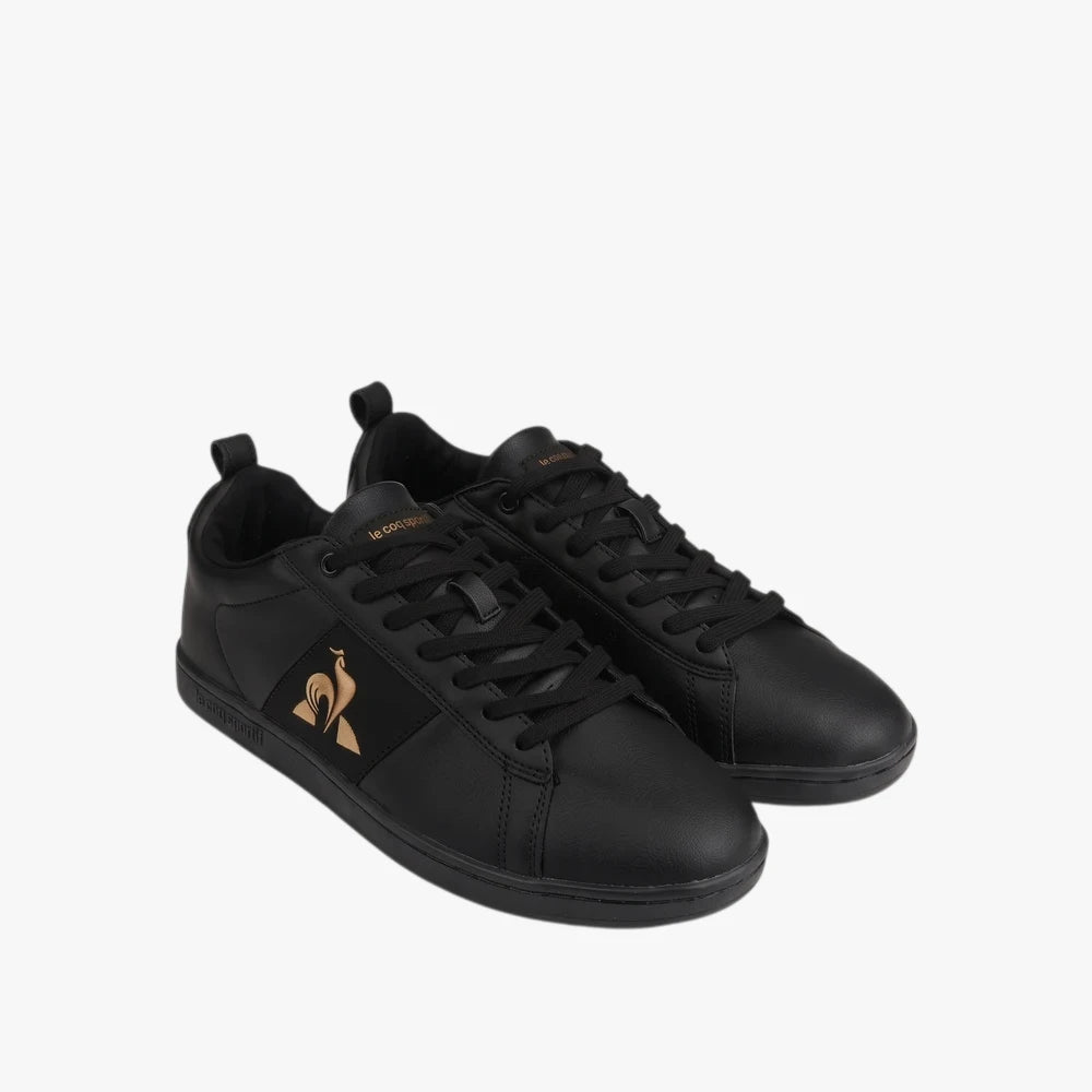 Le Coq Sportif Mens Court Classic Sneaker in black with gold accents and black laces, presented in a studio shot.