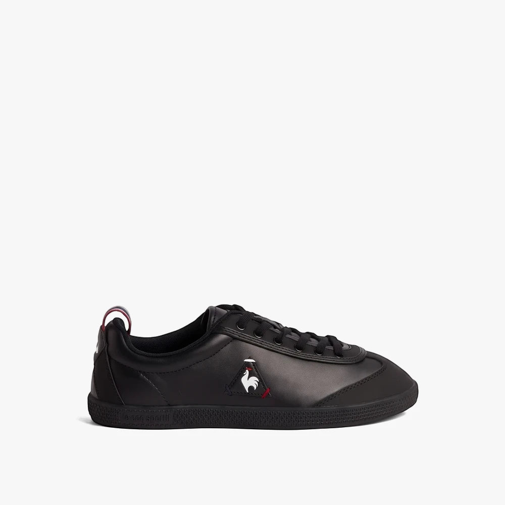 Le Coq Sportif Mens Provencale 11 Black Sneakers. A single black leather sneaker with a white, red, and blue logo, presented
