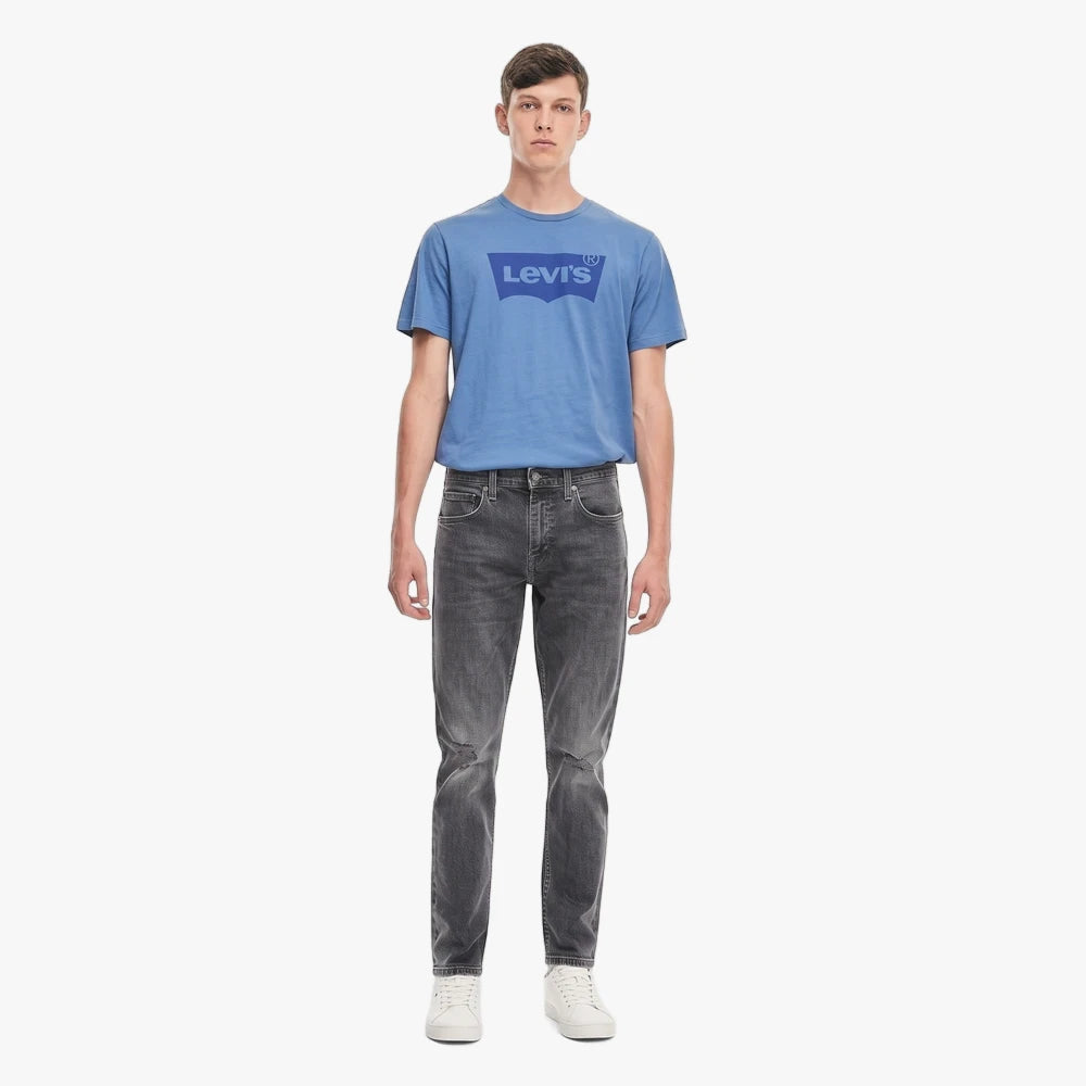 Full body shot of a male model wearing a blue Levi&
