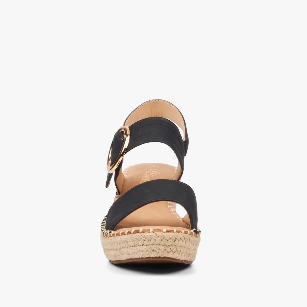 Front view of Miss Black Womens Jayda 9 wedge black sandals featuring a black upper, gold buckle, and braided espadrille