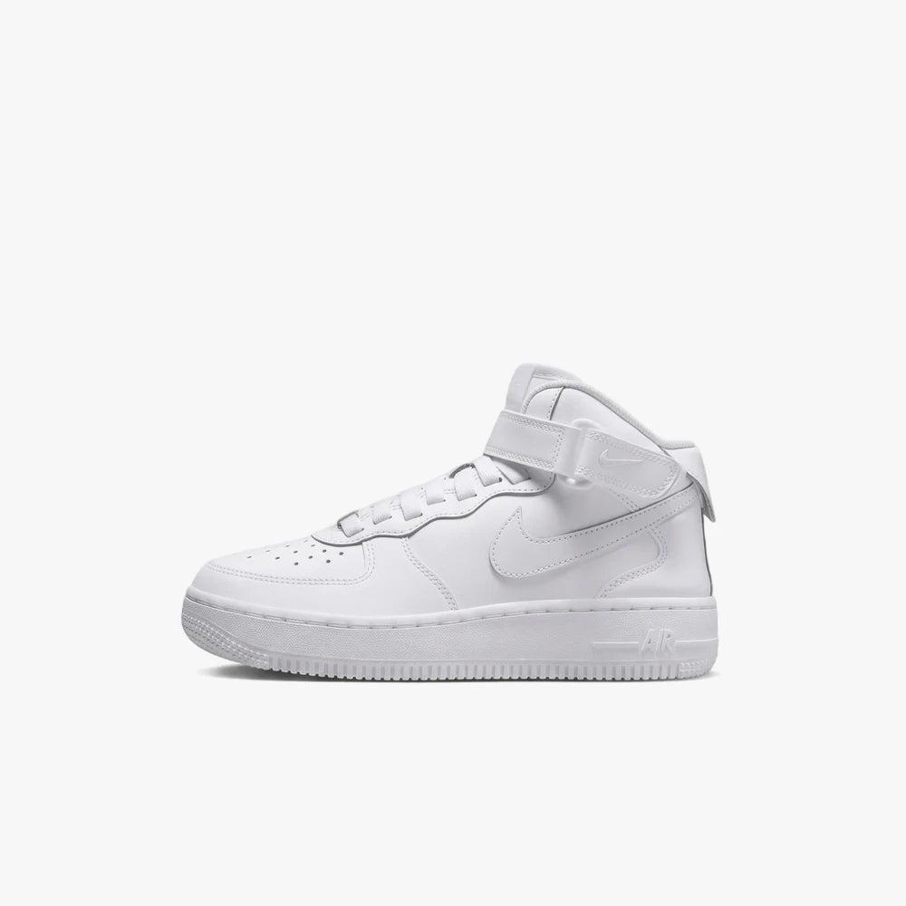 A white Nike Air Force 1 Mid sneaker, featuring a mid-top silhouette and a prominent Nike swoosh, shown from a side view.