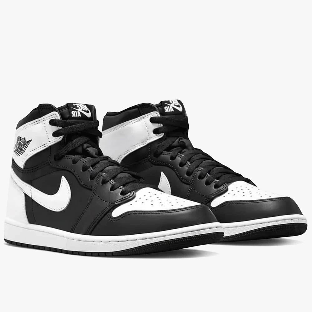 Pair of black and white Nike Air Jordan 1 Retro High OG high-top sneakers, shown from a slightly angled side view.