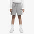 Grey Nike Boys Jersey Shorts with a drawstring waist, worn by a child, paired with a white long-sleeve top and white