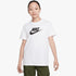 Young girl wearing a white Nike Futura short sleeve tee with a black Nike logo on the chest, paired with green cargo pants.