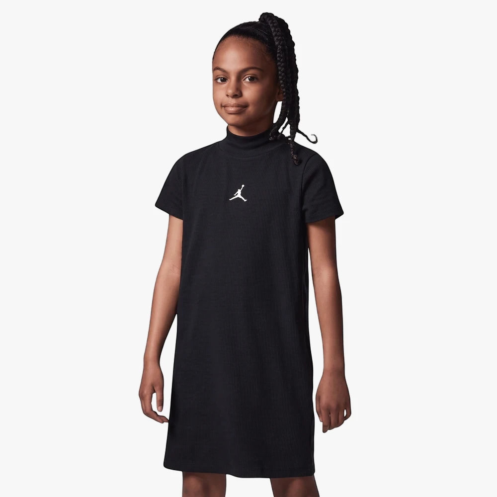 Young girl wearing a black ribbed Nike Jordan Jumpman t-shirt dress with a mock neck, posing frontally.