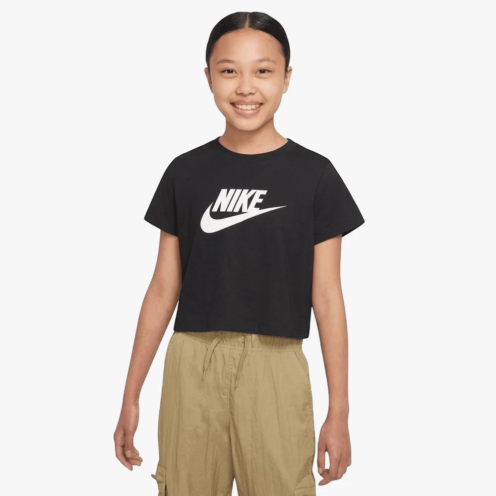 Nike Girls Short Sleeve Crop Tee in black with white logo, worn by a young girl with khaki cargo pants.