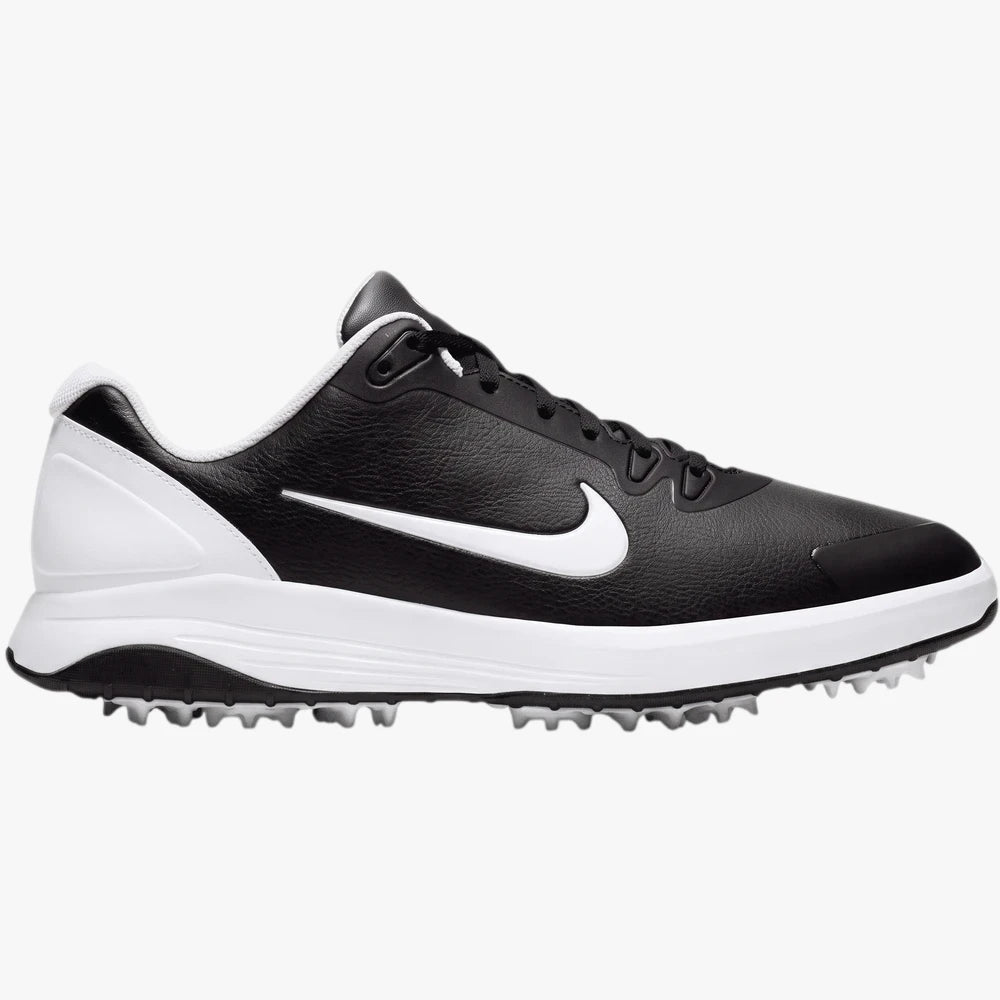 Black and white Nike Mens Infinity Golf Sneaker, side profile view, featuring a prominent white swoosh and a spiked sole for
