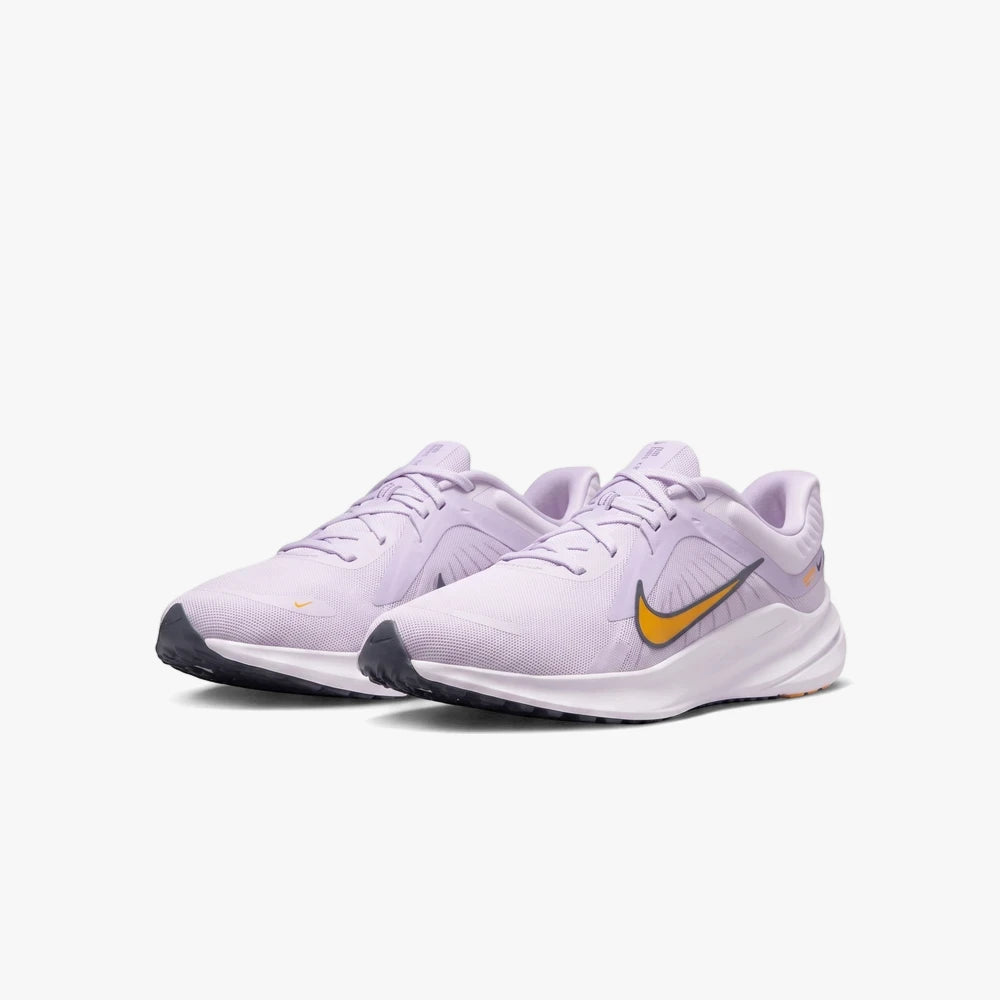 Pair of Nike Womens Quest 5 running sneakers in grape and sundial colors, displayed side by side.