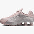 Nike Womens Shox R4 Barely Rose and Metallic Platinum sneaker, side profile view, showcasing its distinct cushioning and