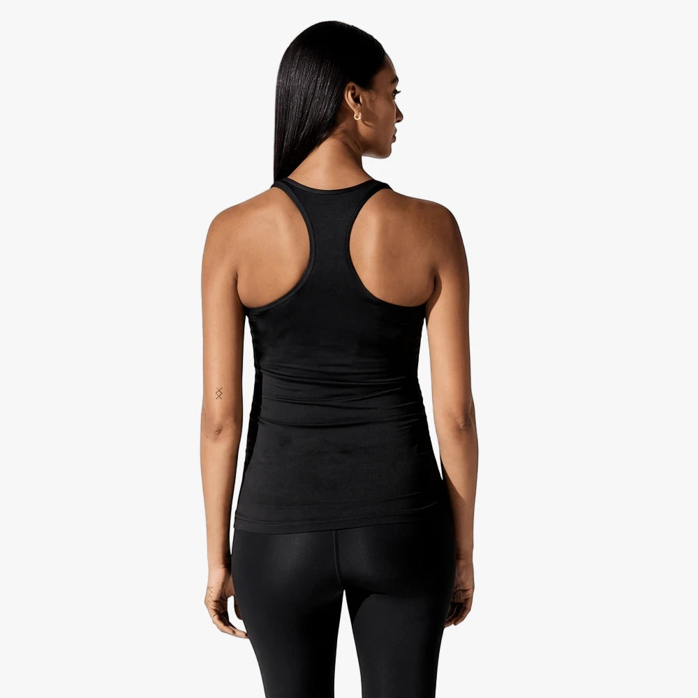 Black Nike Womens Tank Top on a woman, shown from the back, featuring a racerback design, paired with black leggings.