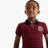 African American boy wearing a Polo Warren Striped Short Sleeve Golfer Red, featuring red and navy horizontal stripes and a