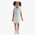 Young girl in a light blue short sleeve Polo golfer dress, featuring an embroidered horse logo and a polo collar, standing
