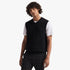 Pringle Mens Ryan Sleeveless Jersey in black, featuring a V-neck, worn by a model over a white t-shirt, studio shot.