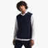 Pringle Mens Ryan Sleeveless Jersey Navy worn by a model, featuring a V-neck and ribbed hem, layered over a white shirt.