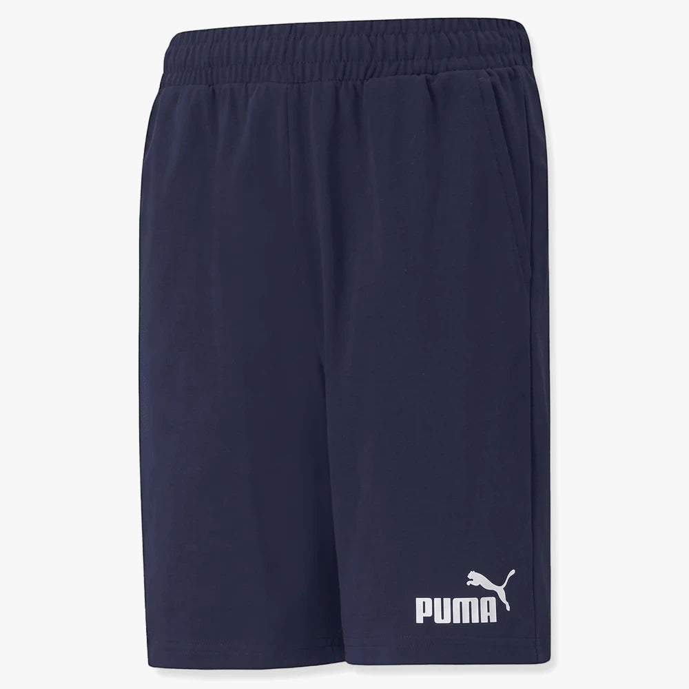 Puma Boys Ess Jersey Shorts in peacoat navy, featuring an elastic waistband and white logo, photographed from the front.
