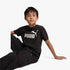 Puma Boys Ess No 1 Logo Short Sleeve Tee in black, featuring the iconic white Puma logo and text on the chest, worn by a