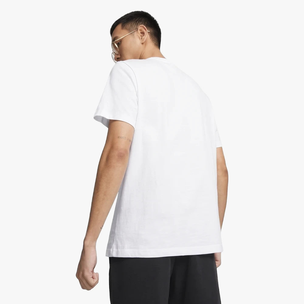 Back view of a male model wearing a white Puma Mapf1 Logo Short Sleeve Tee and black shorts, looking over his left shoulder.