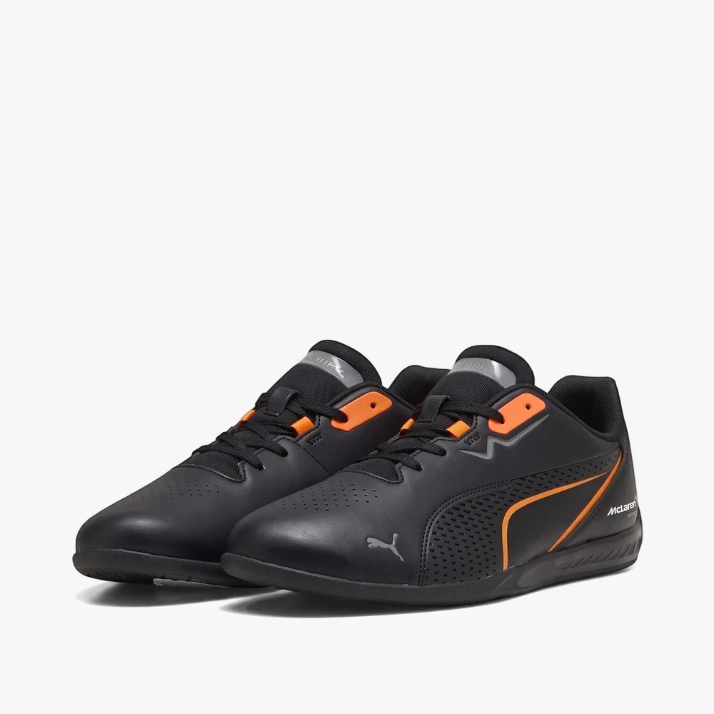 Black and orange Puma Mens Mclaren Drift Cat 11 low-top sneakers with silver accents, displayed on a white background.