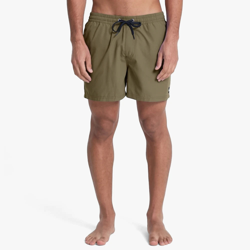 Man modeling Quiksilver Mens Everyday 15 inch Volley Shorts in Green Leaf, with an elastic waistband and drawstring.