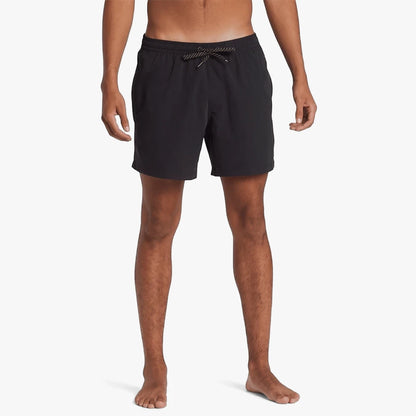 A man models black Quiksilver Everyday Solid Volley 15" shorts, front view, standing with bare feet.