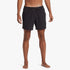 A man models black Quiksilver Everyday Solid Volley 15" shorts, front view, standing with bare feet.