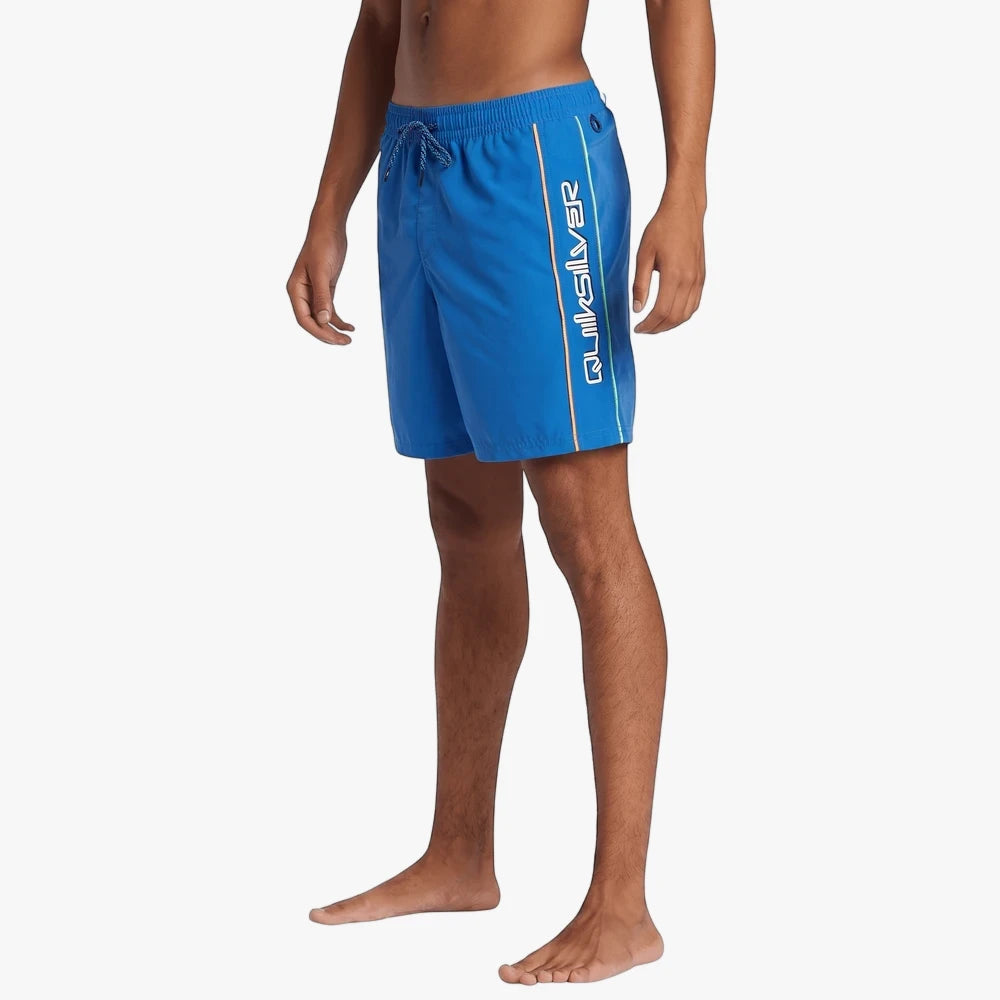 Side view of a man wearing Quiksilver Mens Everyday Vert Volley 2 17-inch shorts in nebulas blue, featuring a vertical logo