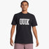 A male model wearing a black Quiksilver Griff short sleeve tee with a white &