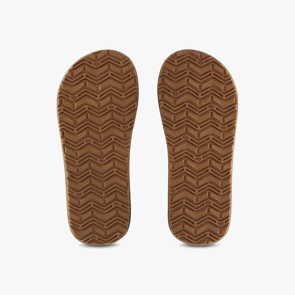 Brown Quiksilver Mens Monkey Wrench Core Sandals. Bottom view displays textured rubber soles with wavy tread patterns and
